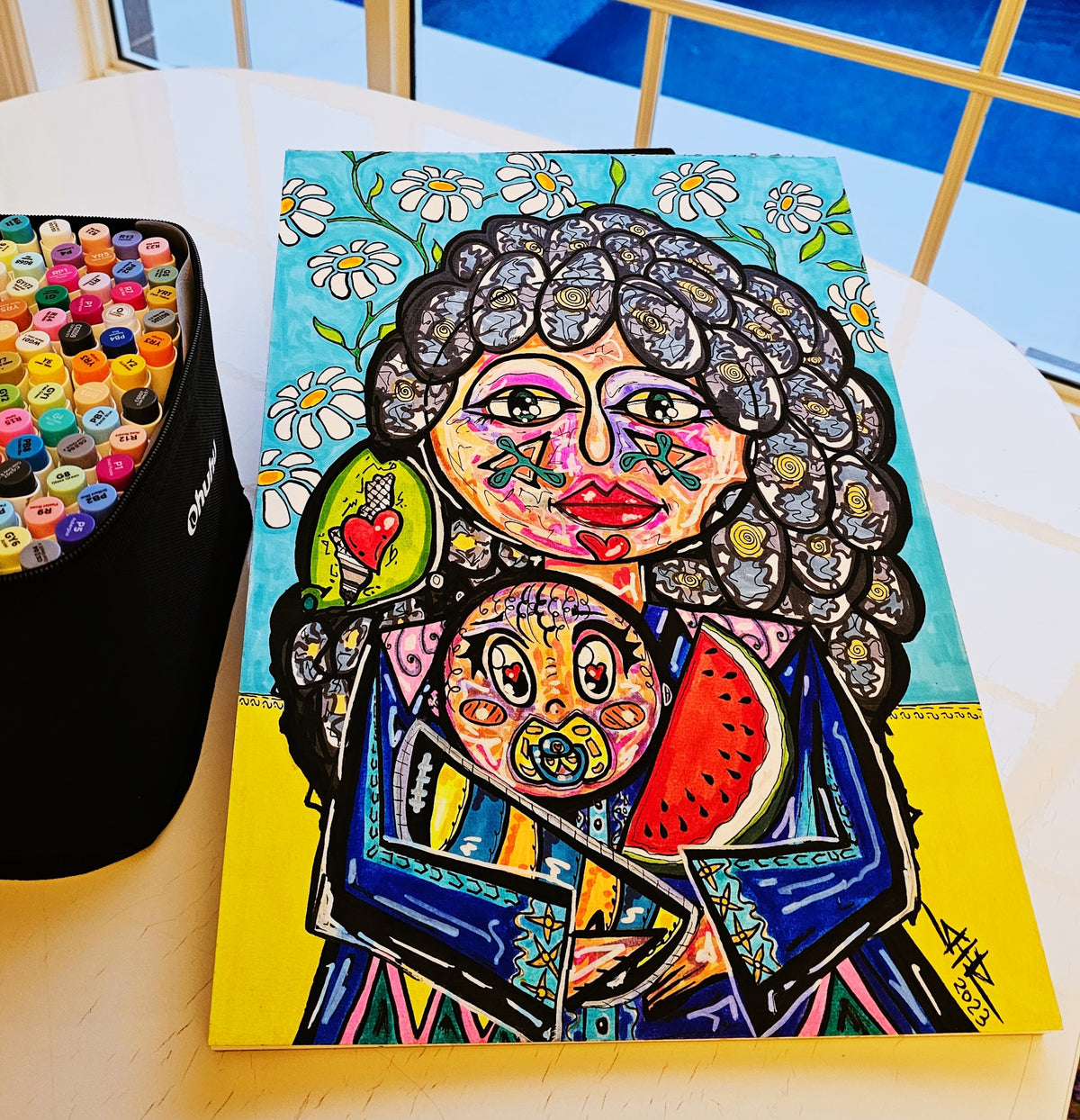 Rafah: the painting propped at an angle on a table beside a pot of marker pens