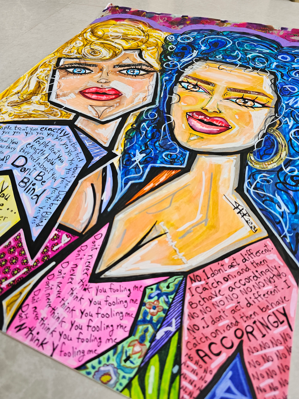 Karma & Charma: the canvas laid at an angle on a grey floor, showing the whole painting
