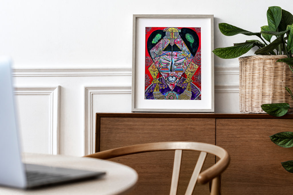Bishop print framed in wood on a sideboard in a bright home office, beside a large leafy plant