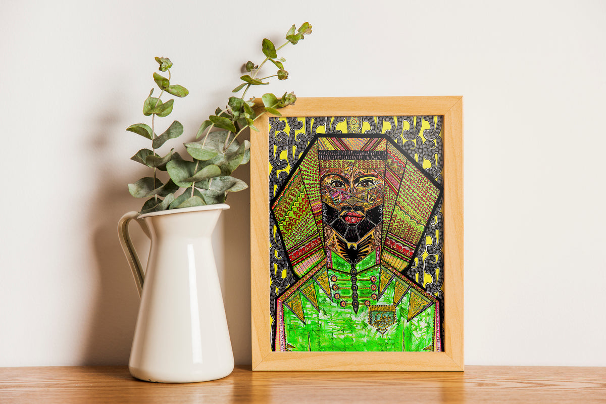 Nimer print framed in oak on a timber surface, beside a cream jug of dried eucalyptus