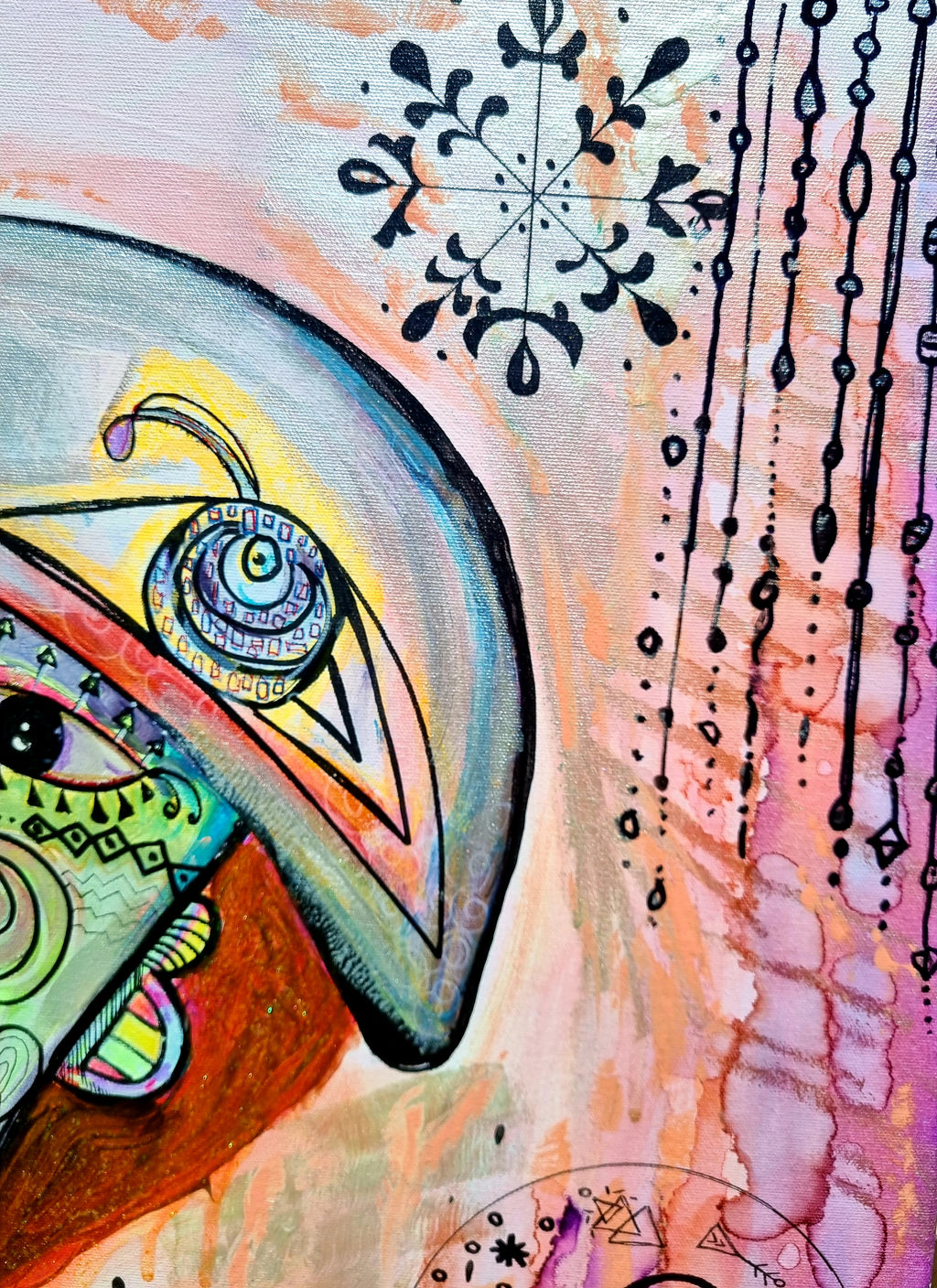 Rosado detail: a blue eye under a yellow lid, with inked snowflakes and hanging bead lines