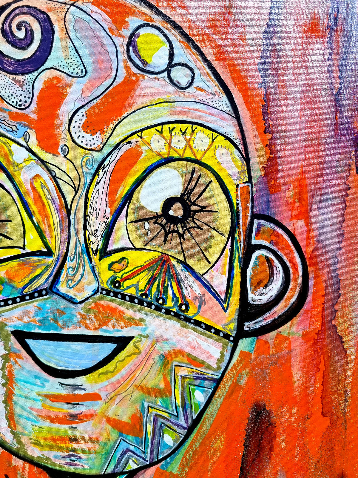 Naranja detail: the face, two yellow almond eyes with lashes above a wide blue smile