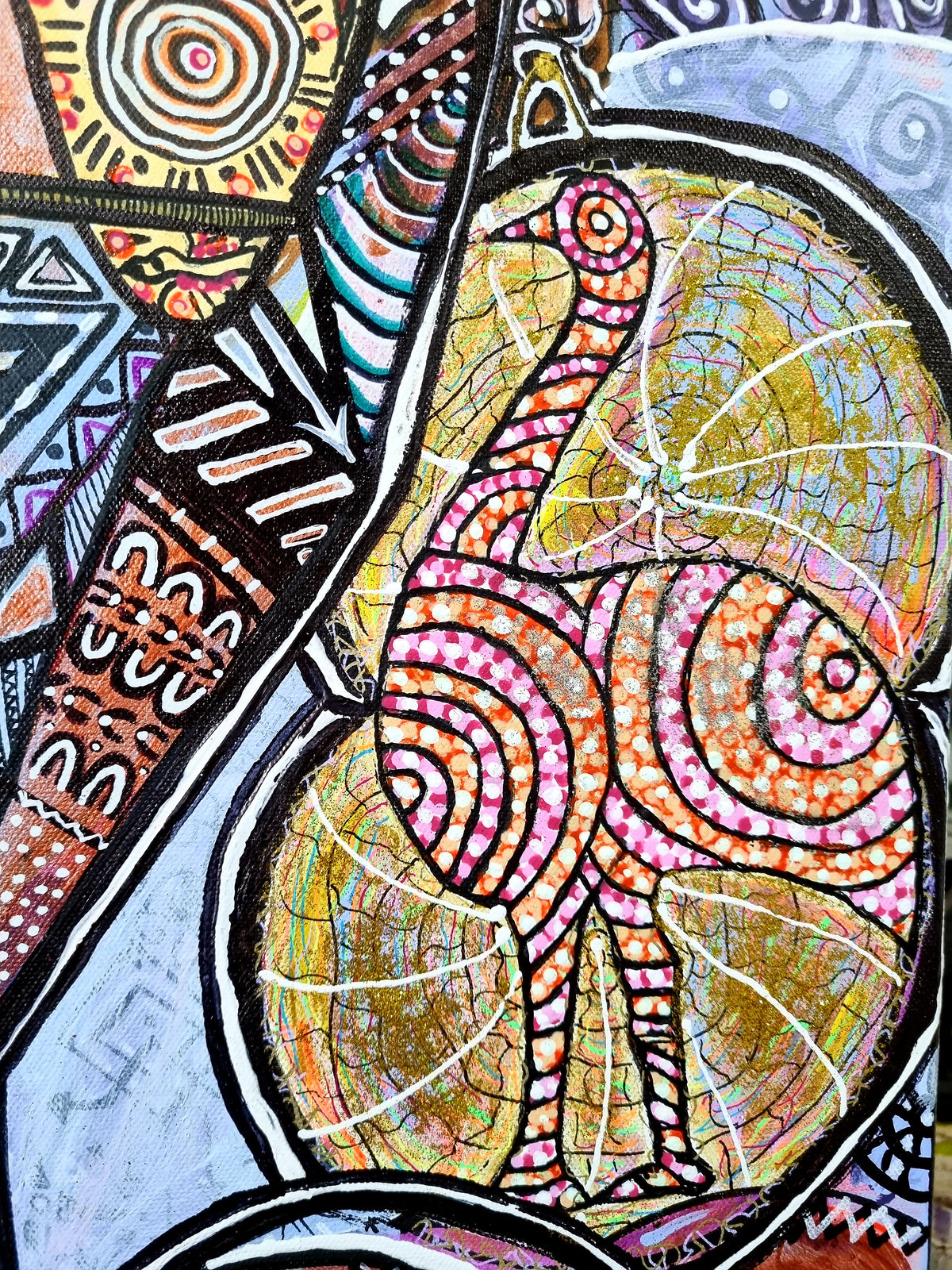 Wiana detail: a golden bird with pink spiral markings standing over a crackled gold disc