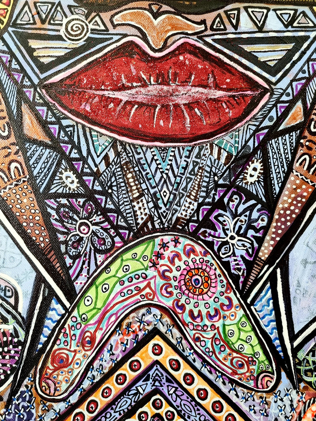 Wiana print detail: full red lips framed by black and white triangles and beaded chevrons