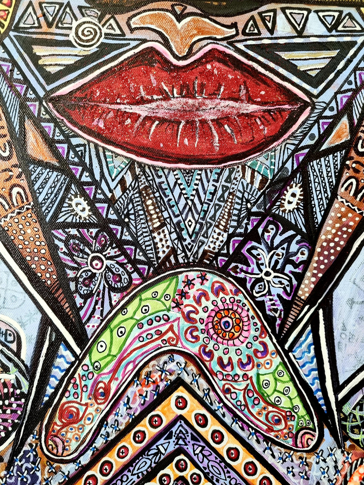 Wiana print detail: full red lips framed by black and white triangles and beaded chevrons