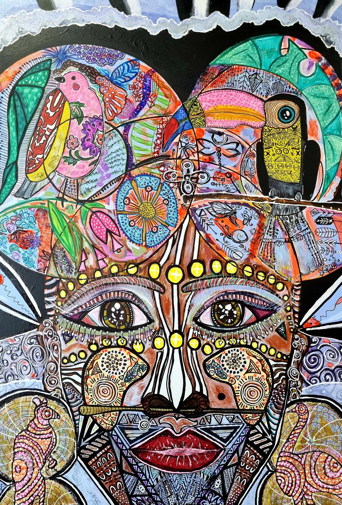 Wiana detail: the upper face, with beaded brow, third eye markings and a toucan above the head