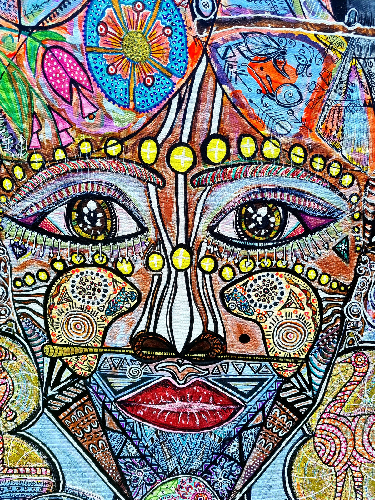 Wiana detail: the figure's face, almond eyes, a dotted brow line and deep red lips