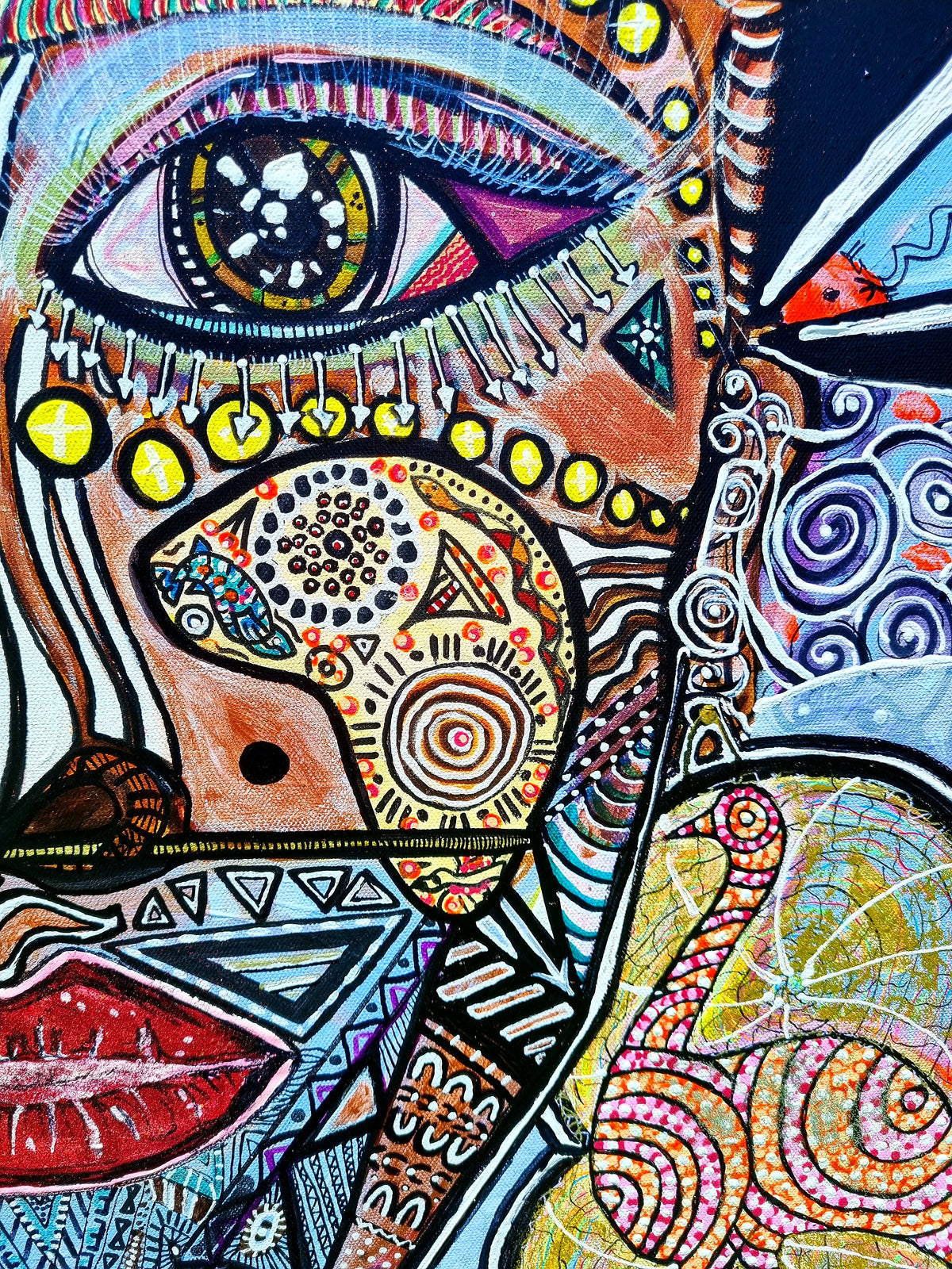 Wiana detail: one wide eye with a starry blue iris above a pair of full red lips