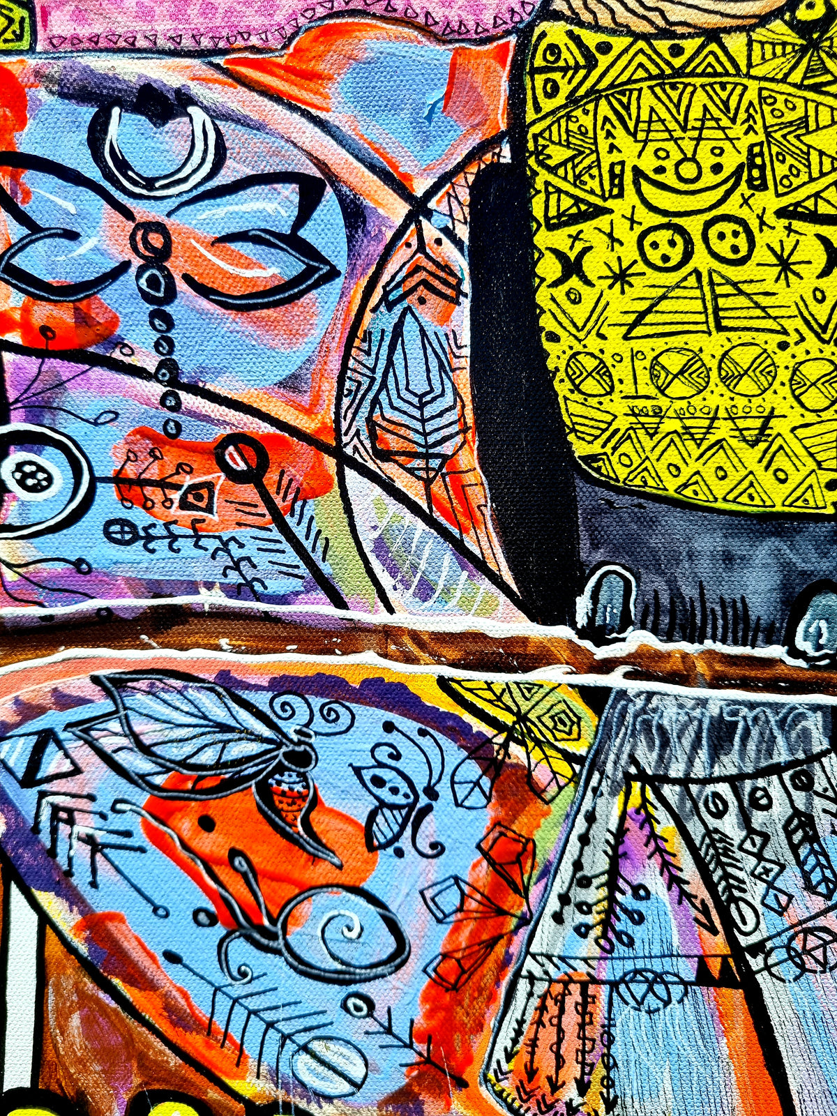 Wiana detail: a bright yellow panel of hand drawn symbols with dragonflies floating around it