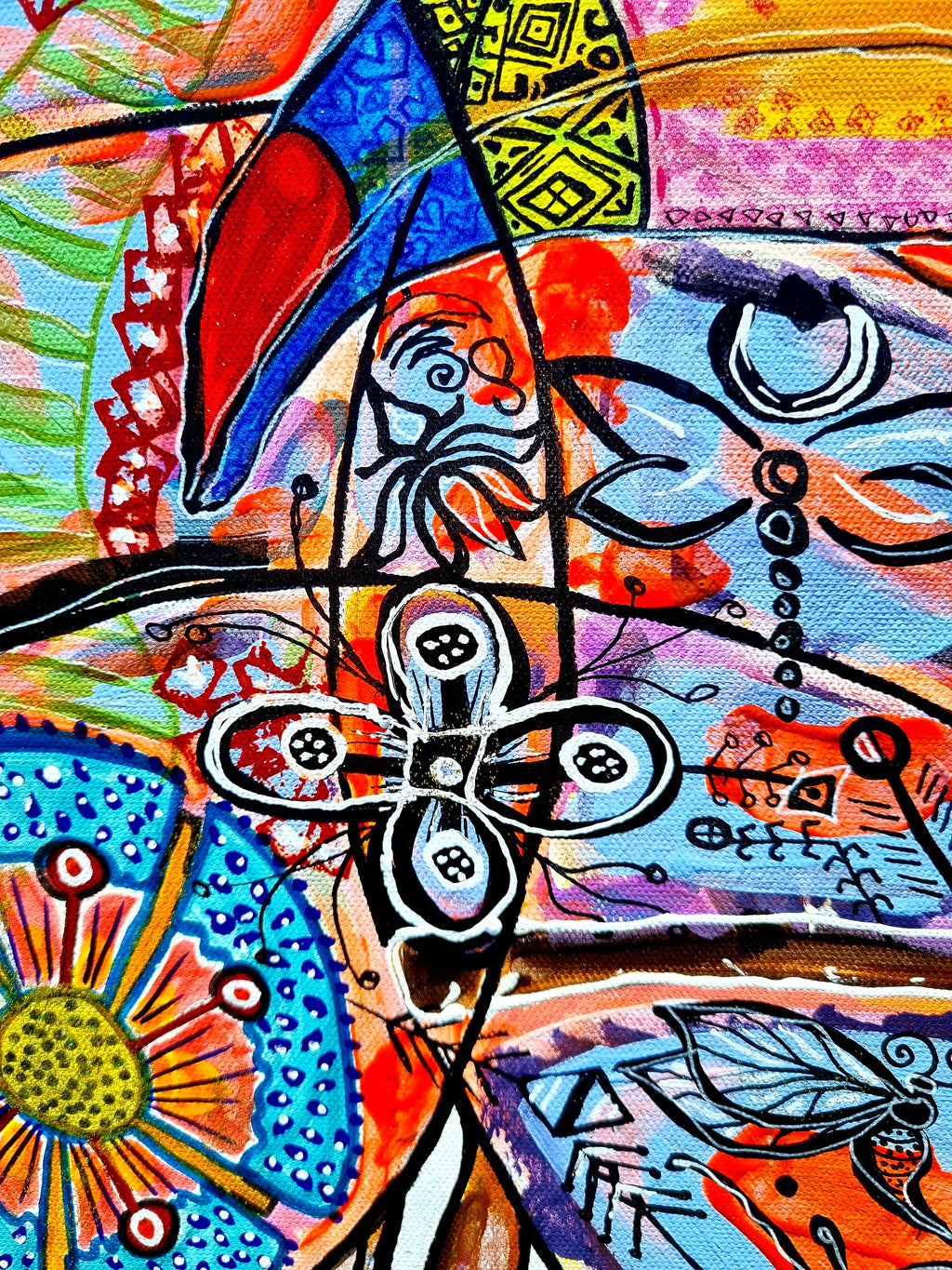 Wiana detail: a red and blue wing shape beside a four petal flower and an orange sunburst