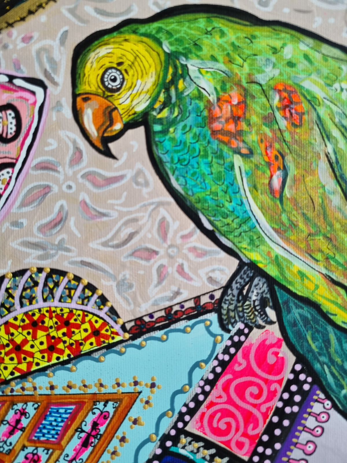 Kitty Kat detail: a green parrot with a yellow head and orange beak perched above patterned panels