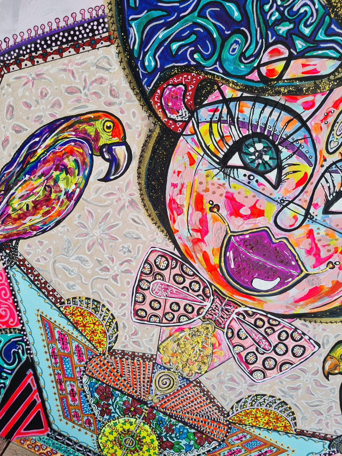 Kitty Kat detail: a rainbow parrot with a blue beak turning towards the cat's magenta mouth