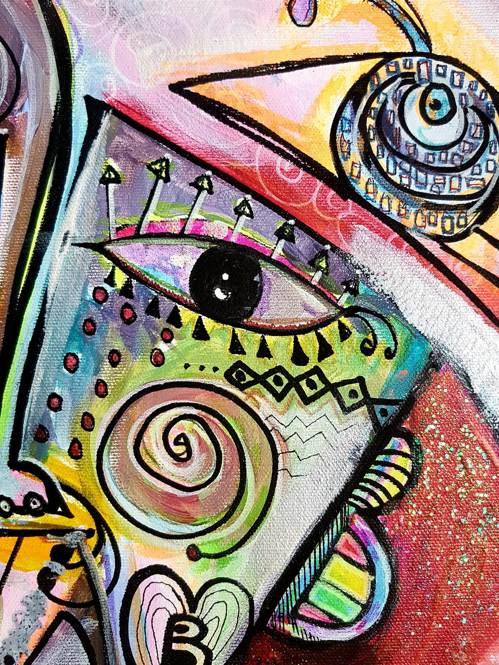 Rosado detail: two eyes above a coiled spiral, with zigzag bands in lime, yellow and rose