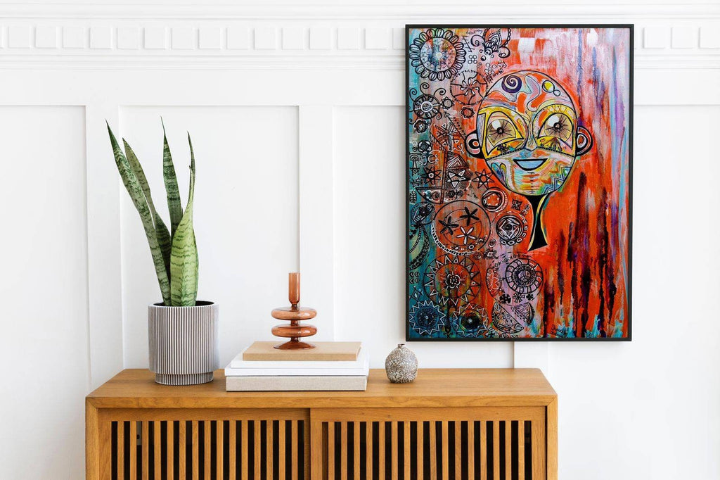 Naranja in a black frame on a panelled white wall above a slatted timber cabinet