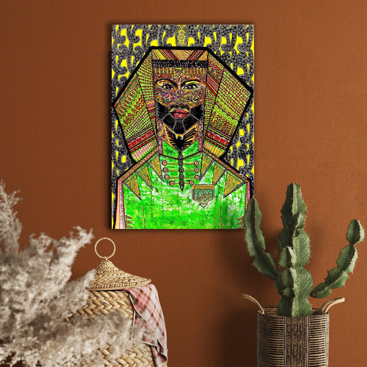 Nimer on a terracotta wall beside a tall cactus and a vase of dried pampas grass