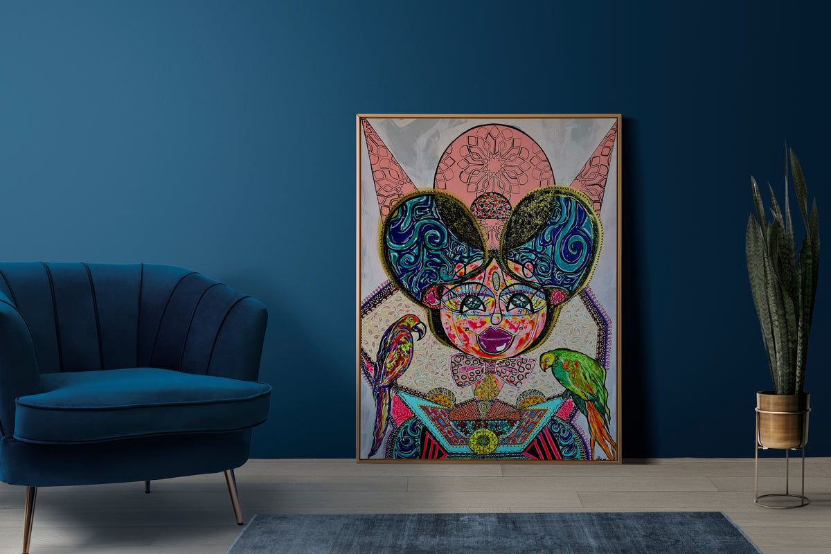 Kitty Kat framed on a deep blue wall beside a navy velvet armchair